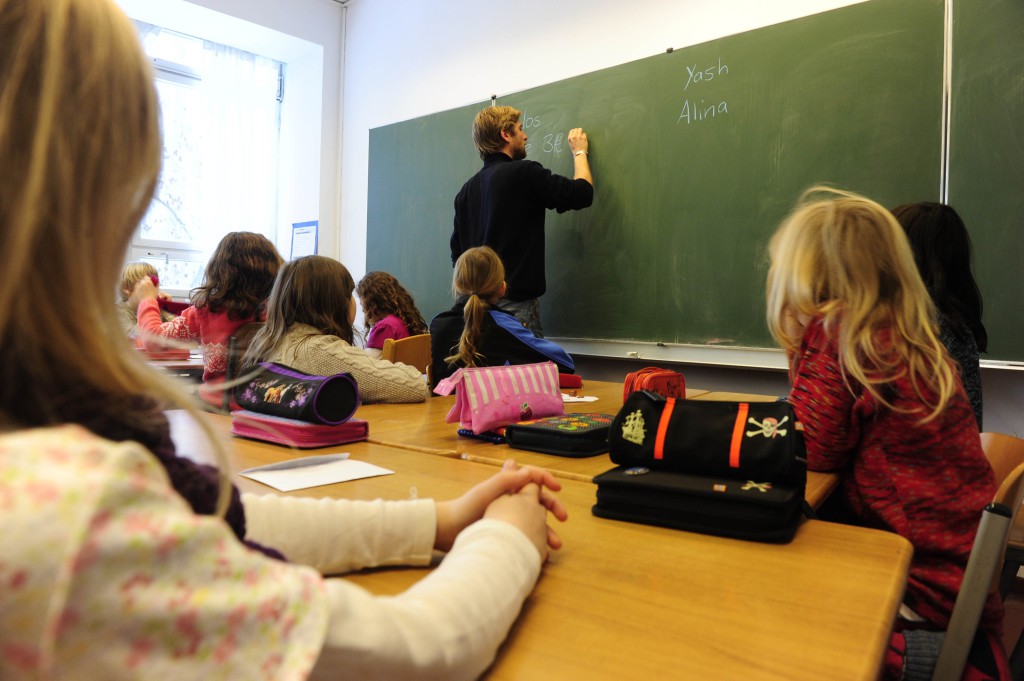 A teacher writes on the blackboard during class in a primary school in Berlin December 7, 2010. The three-yearly OECD Programme for International Student Assessment (PISA) report, which compares the knowledge and skills of 15-year-olds in 70 countries around the world, ranked Germany in the middle field for reading skills and above the OECD-average for mathematics and natural sciences. Teenagers from the Chinese city of Shanghai have the best education in the world, according to the major international study. AFP PHOTO / JOHN MACDOUGALL (Photo credit should read JOHN MACDOUGALL/AFP/Getty Images)